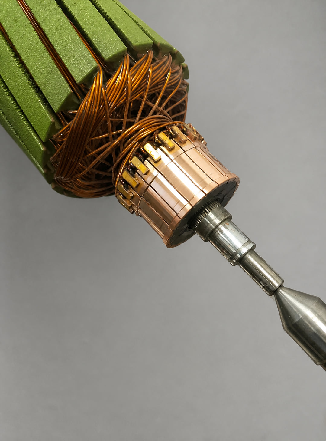 Close-up of a freshly machined AutoStore robot drive motor commutator, showing bright copper segments with clean undercut insulation